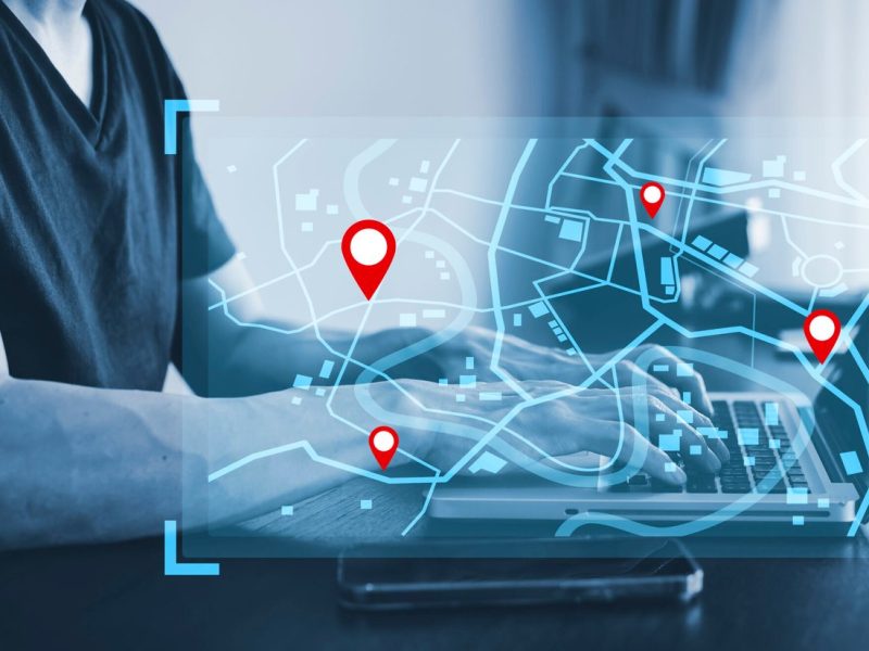 man-using-laptop-with-virtual-world-model-map-with-location-point-gps-app-icon-travel-maps-find-places-online-system-all-screen-graphics-are-generatedsearching-travel-scaled.jpg