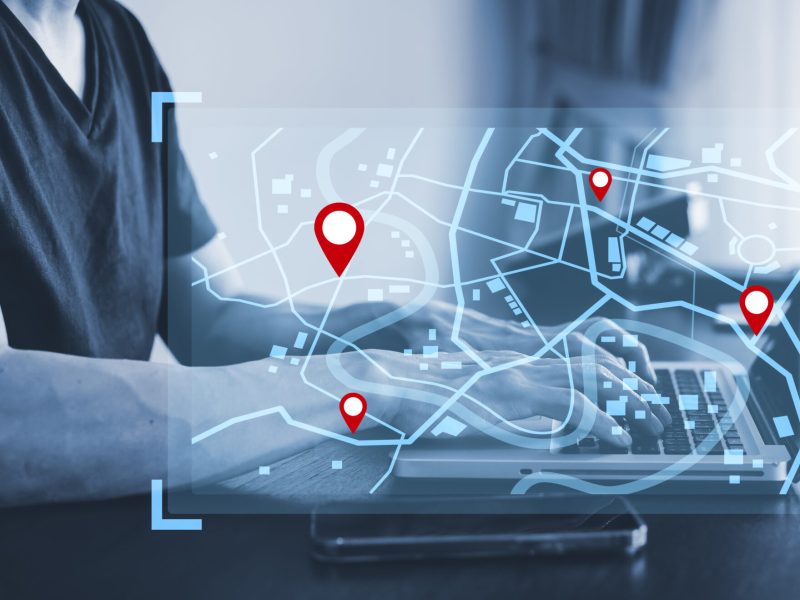man-using-laptop-with-virtual-world-model-map-with-location-point-gps-app-icon-travel-maps-find-places-online-system-all-screen-graphics-are-generatedsearching-travel-scaled.jpg